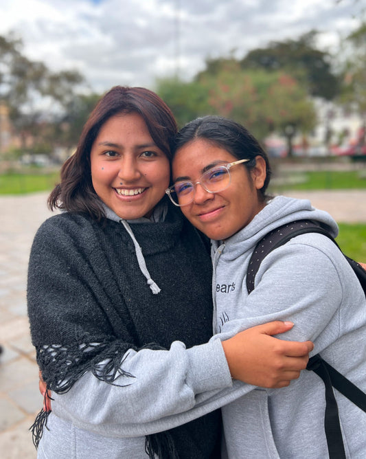 Two Peruvian scholars hugging 