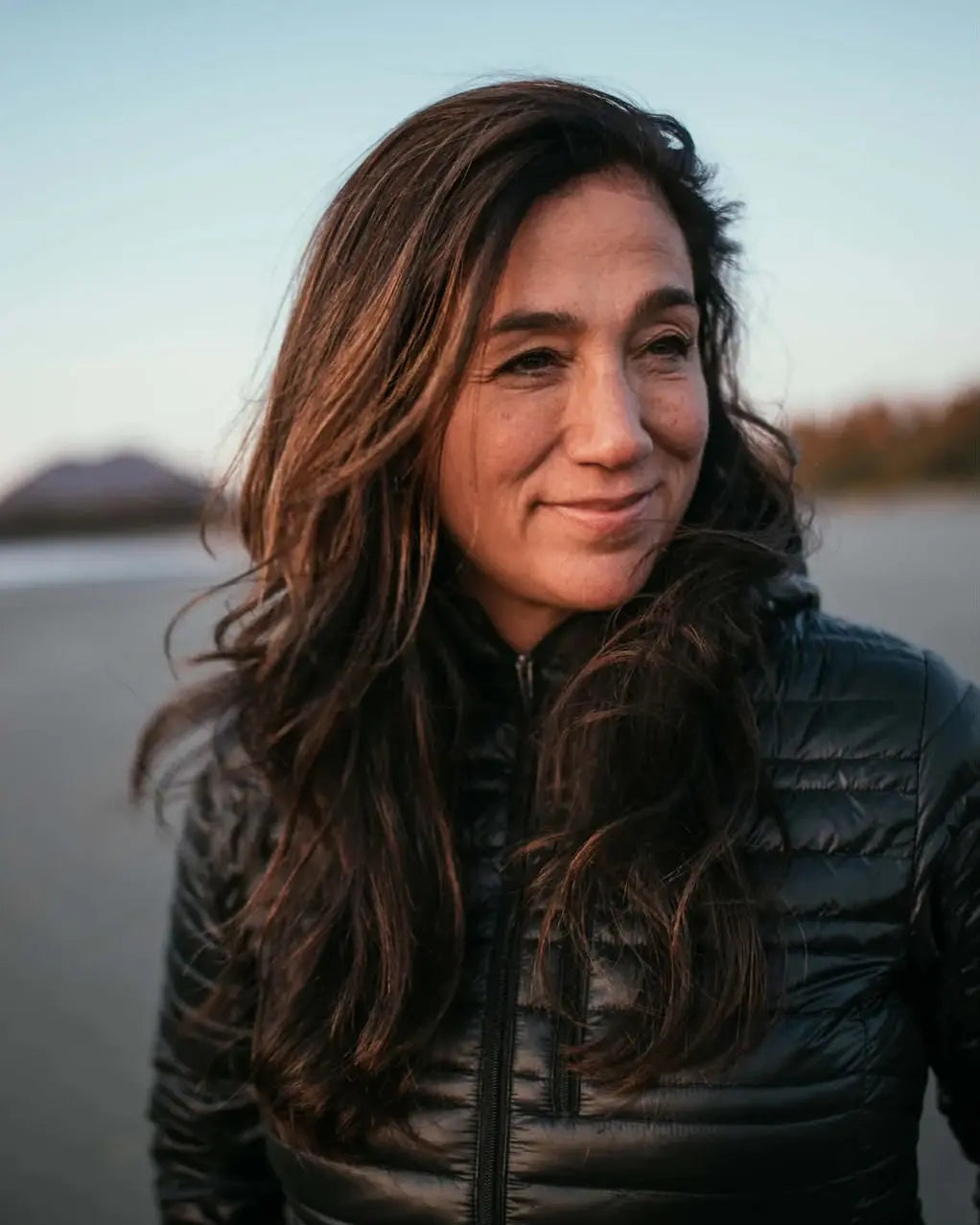 PAKA Ambassador Cristina Mittermeier, Founder of SeaLegacy, in Puffy Jacket with Hills in Background