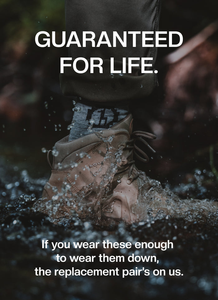 Text Reading "Guaranteed for Life. If you wear these enough to wear them down, the replacement pair's on us." with Alpaca Sock Showing Above Hiking Boot Stamping in Water