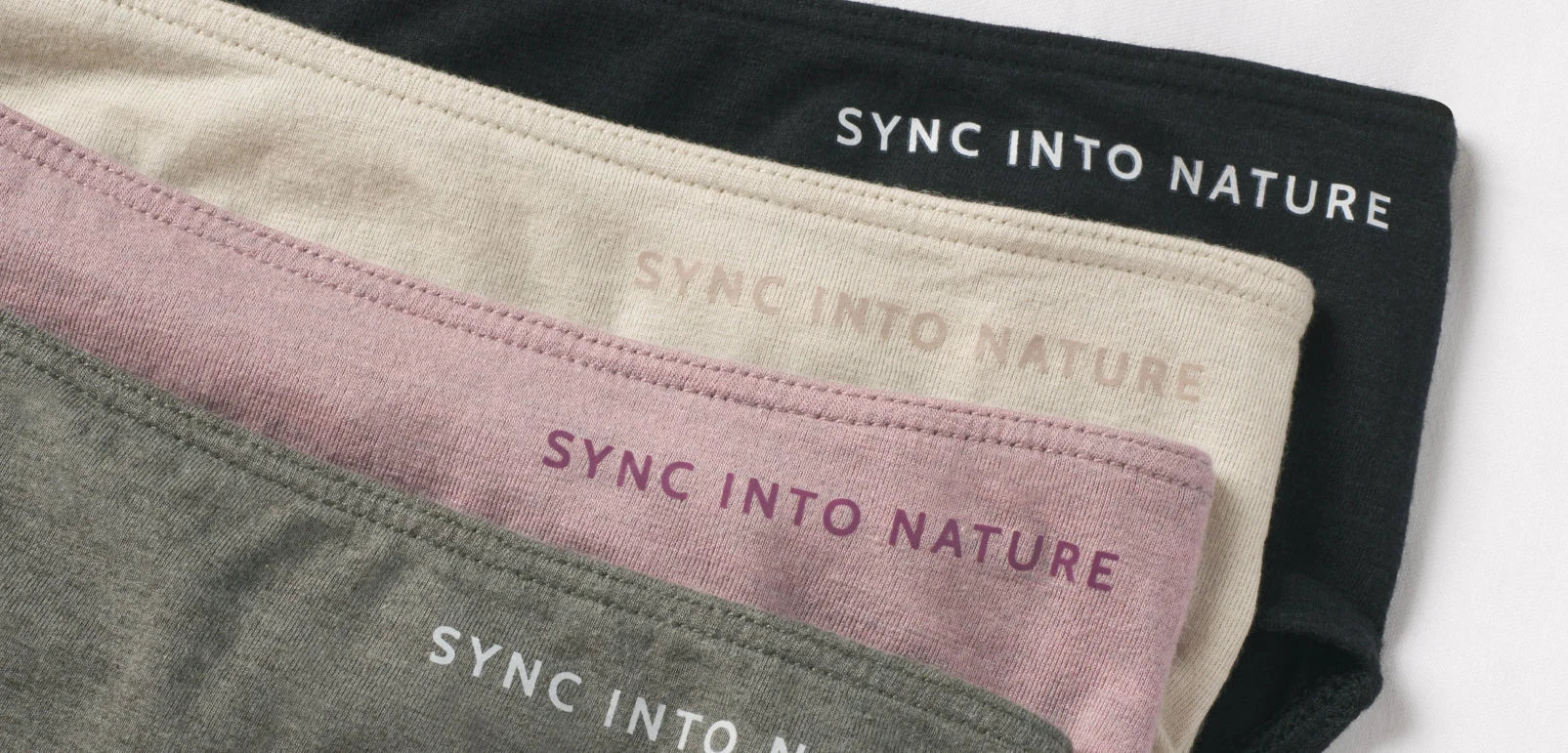 Our Women's alpaca underwear in black, birch, quail and forage. They say "sync into nature"