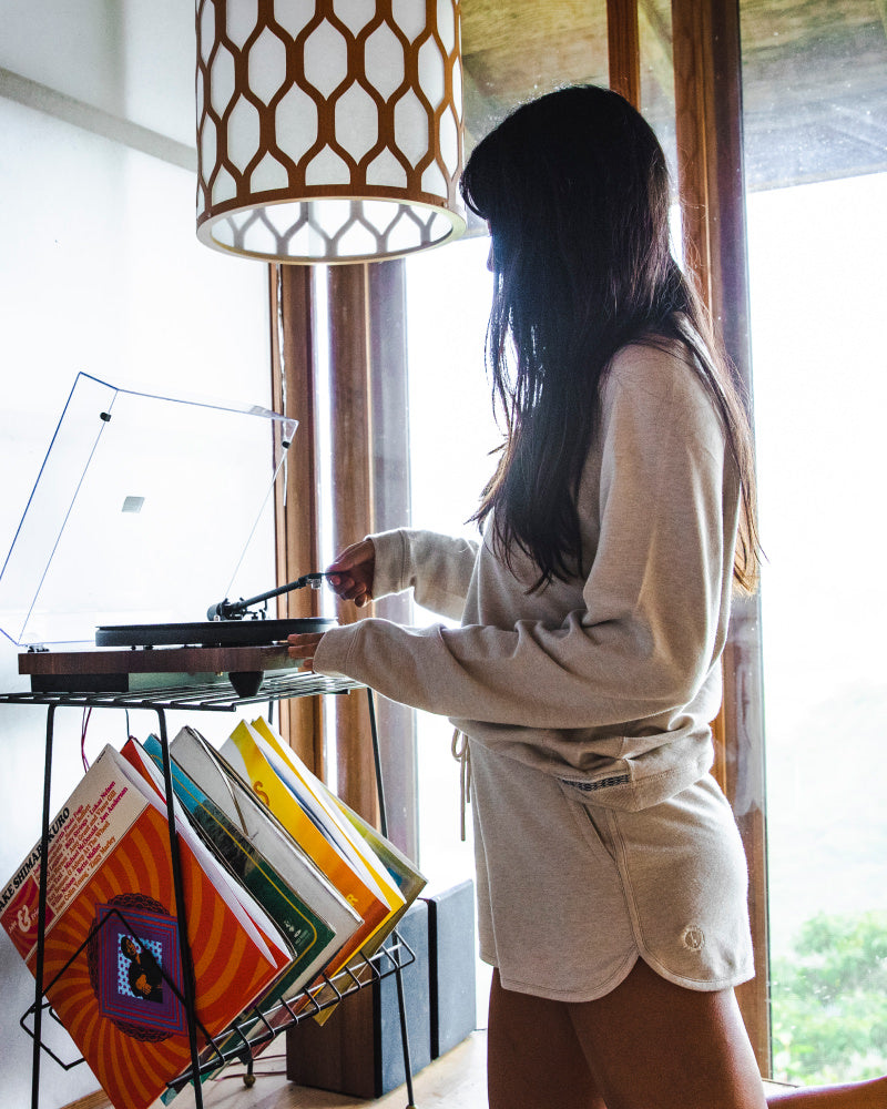 Woman wearing Women's Tri-blend Shorts playing a record