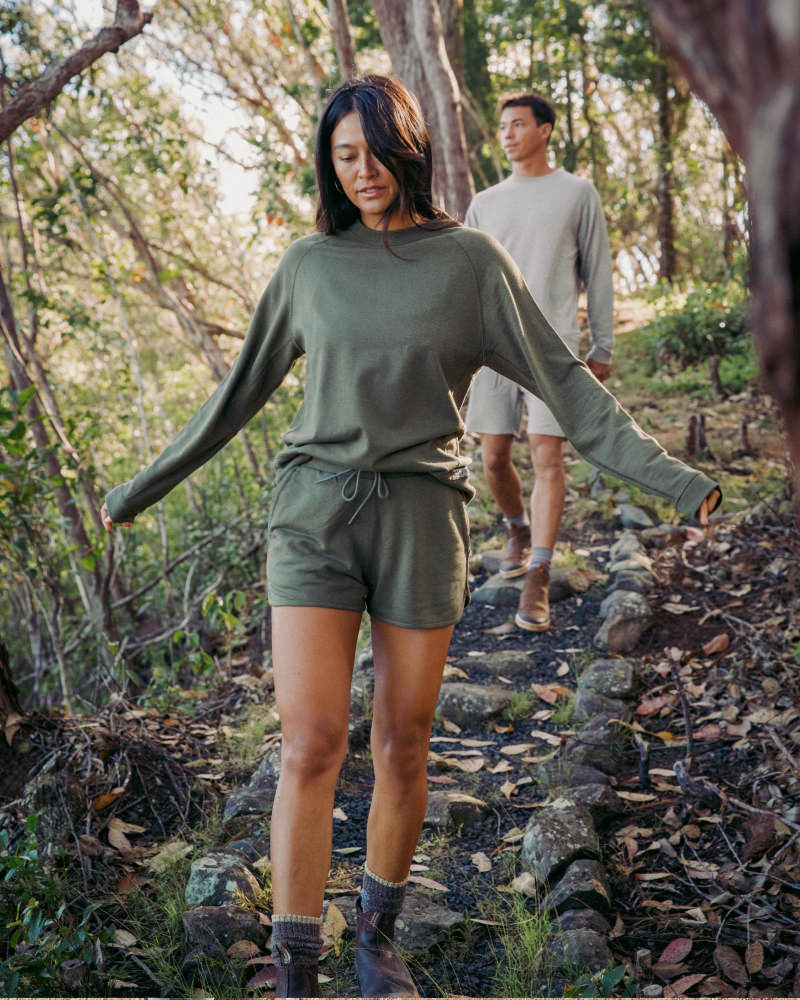 Woman Hiking in Forest in Andean Moss / Dark Green Tri-Blend Terry Shorts with Male Hiking Partner Behind – PAKA Apparel