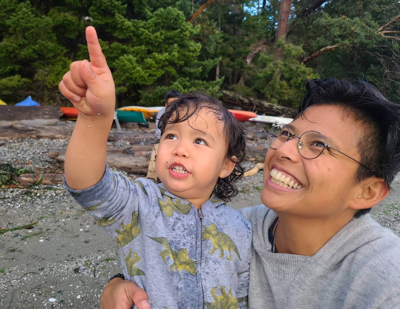 Person Wearing Sustainable Light Gray Alpaca Hoodie Holding Baby Pointing Up - PAKA Apparel