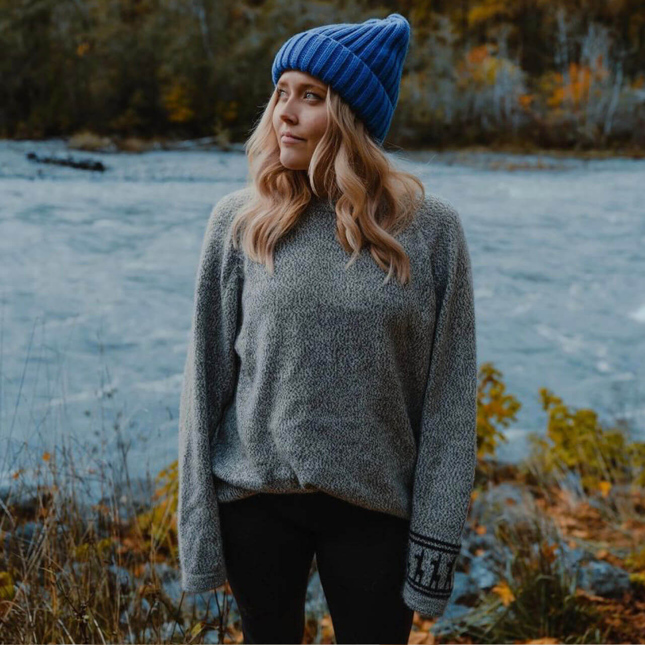 Woman Wearing The Costa Sustainable Alpaca Wool Sweater in Front of River - PAKA Apparel