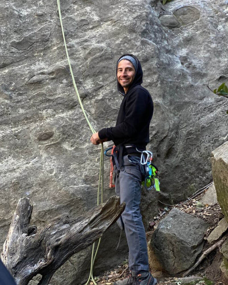 Man Wearing Alpaca Outdoor Activewear While Rock Climbing - PAKA Apparel