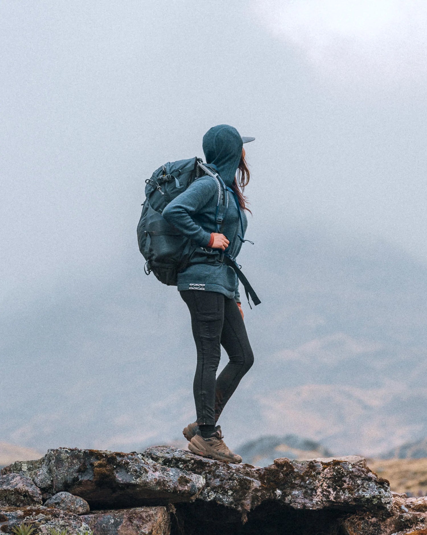 Woman Hiker with Pack in Mountains Wearing Navy Blue Alpaca Hiking Hoodie – PAKA Apparel