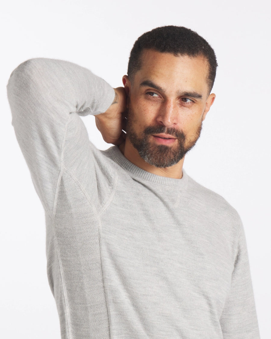 Light Grey Ultralight Crewneck Sustainable Alpaca Sweater on Man with Hand Raised Behind Neck - PAKA Apparel