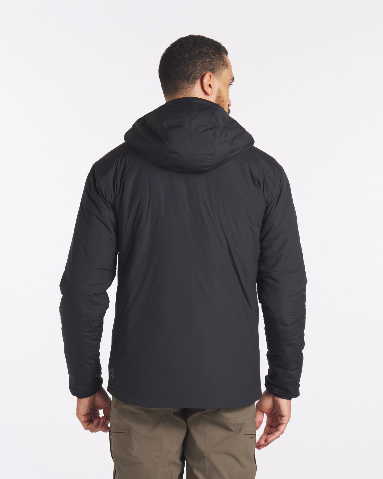 Backside of Man in Black Apu Lightweight Sustainable Puffer Jacket – PAKA Apparel