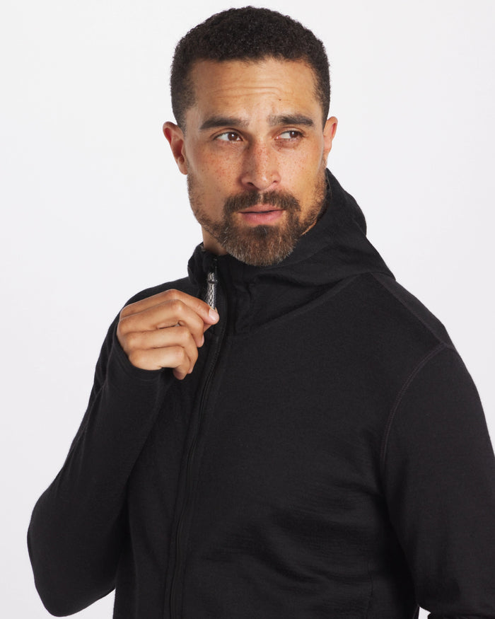 Man Wearing Black Breathe Men's Full-Zip Lightweight Alpaca Blend Hoodie While Gripping Zipper – PAKA Apparel