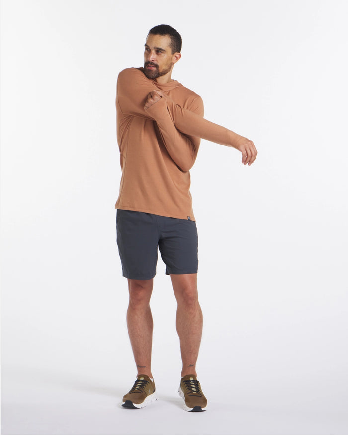 Man stretching while wearing Men's Sol Hoodie