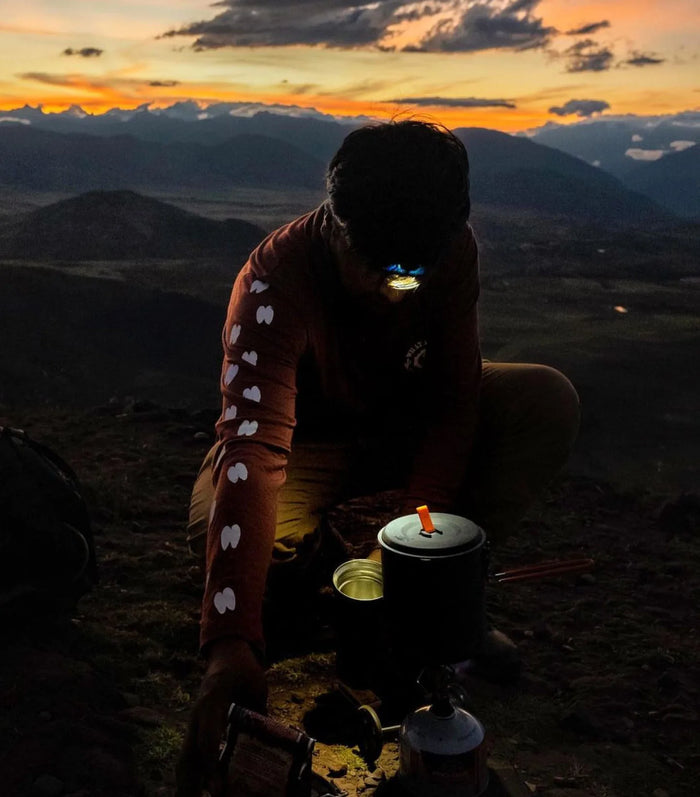 Man in Mountains at Dusk Cooking with Headlamp in Sebastian Natural Fiber Alpaca Wool Baselayer - PAKA Apparel