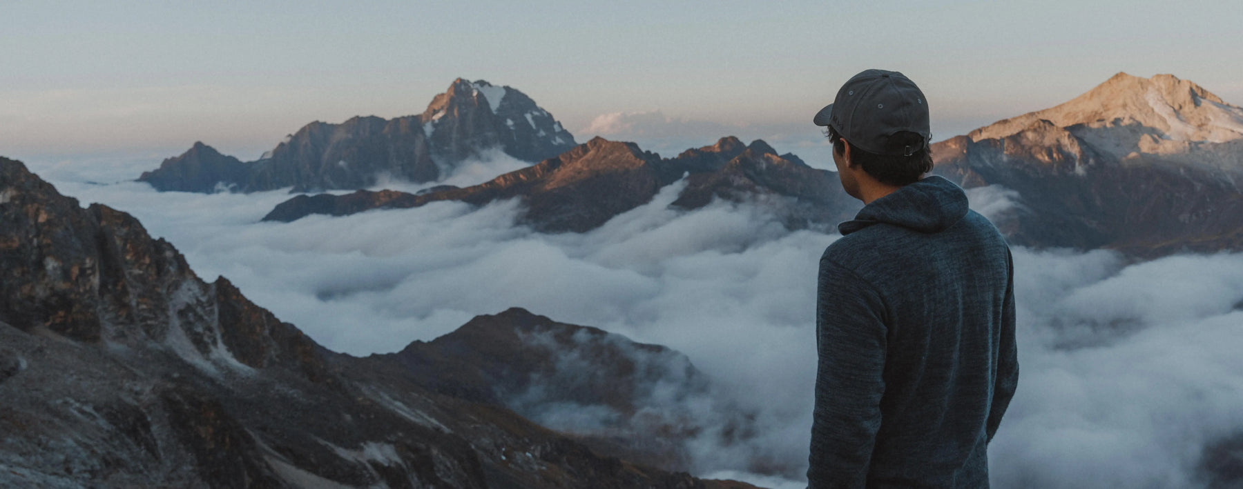 Man Looking at Peruvian Mountain Peaks Above Clouds in Dark Grey Alpaca Wool Sweater Hoodie – PAKA Apparel