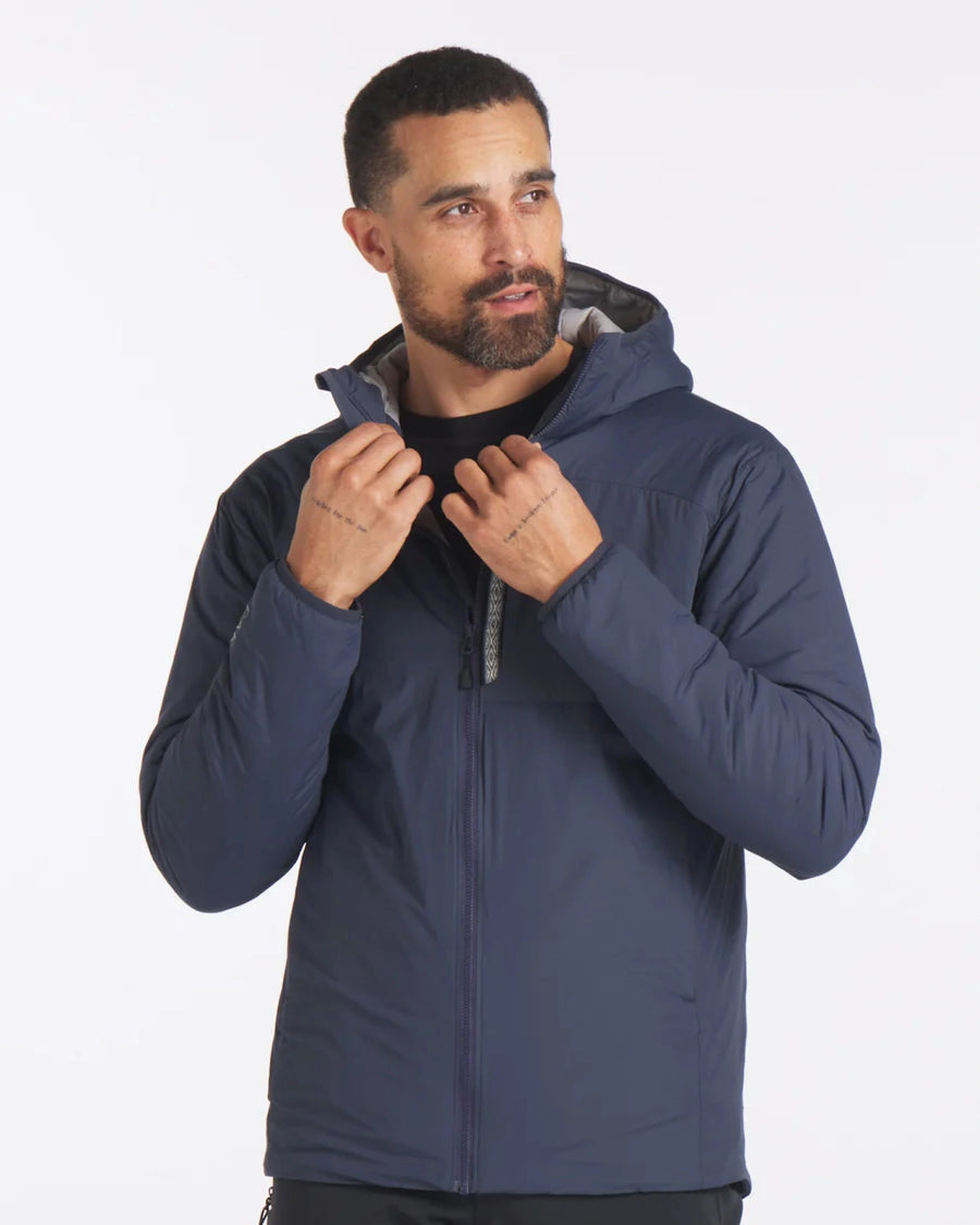 Model Wearing Apu Navy Men's Sustainable Lightweight Puffer Jacket with PAKAFILL® Alpaca Insulation from Peru – PAKA Apparel