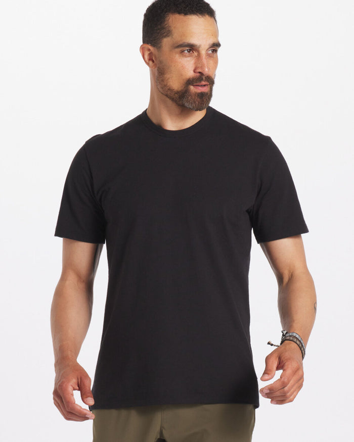 Man wearing the black Men's Tee