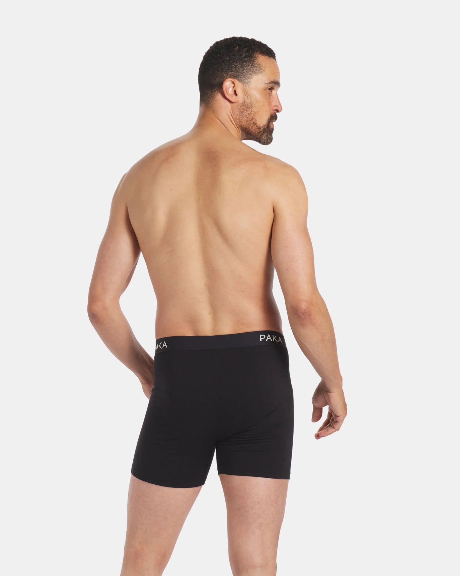 Backside of Man Wearing Men's Black Alpaca Natural Underwear Boxer Briefs – PAKA Apparel