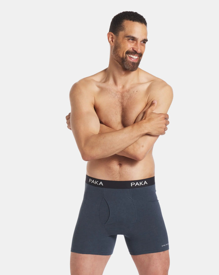 Model Smiling with Arms Crossed in Blue Men's Breathable Natural Underwear – PAKA Apparel