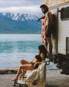 Bearded Tattooed Man in Alpaca Boxer Briefs and Tattooed Woman in Alpaca Bralette and Underwear Outside Camper by Lake and Mountains – PAKA Apparel