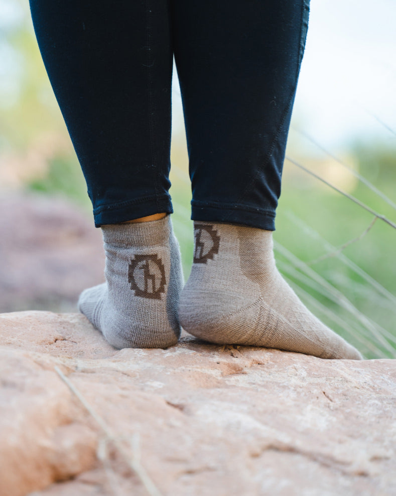 Woman wearing trail socks from back