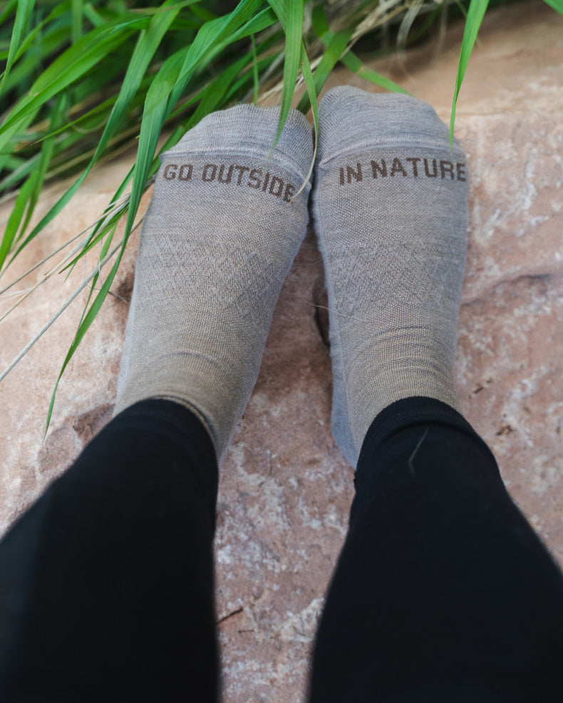 Walnut / Tan Trail Peruvian Alpaca Quarter Crew Socks on Feet from Above with “Go Outside in Nature” Text – PAKA Apparel