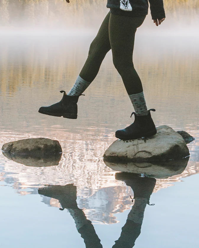 Woman model wearing Sebastian Crew Socks walking on rocks