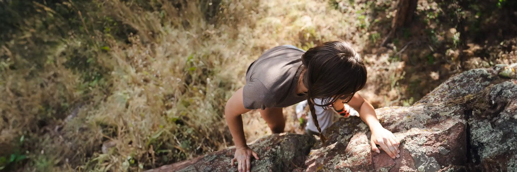 Woman wearing brown alpaca tee climbing 