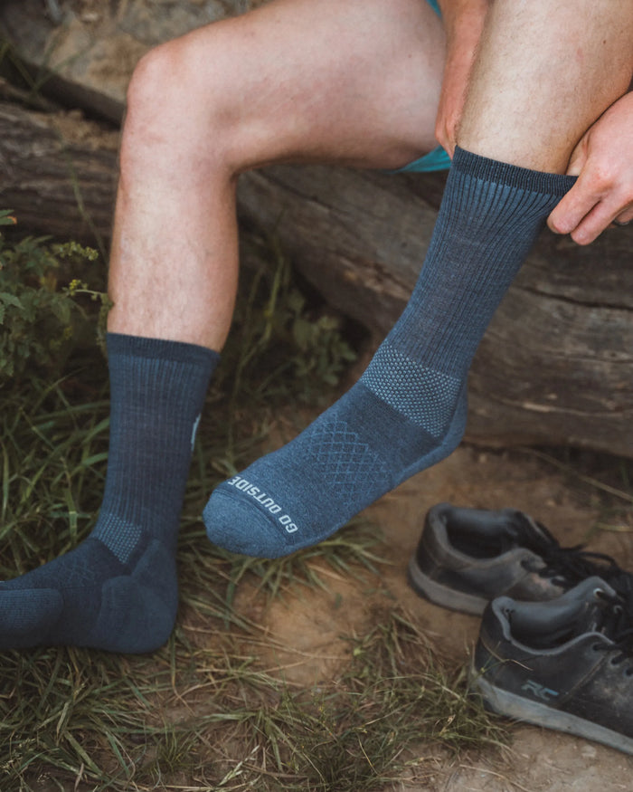 Man putting on alpaca wool sock