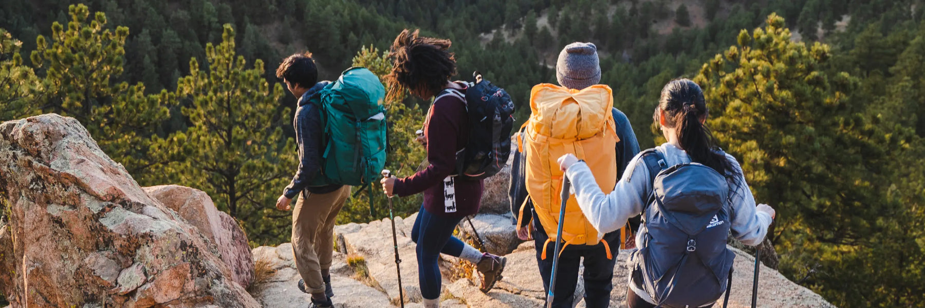 A group of people hiking in the nature. They are wearing alpaca sweaters 