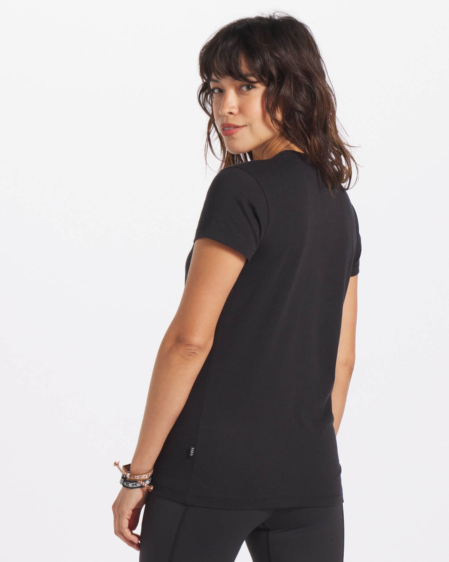 Woman Looking Over Shoulder Wearing Black Breathable Alpaca V-Neck T-Shirt – PAKA Apparel