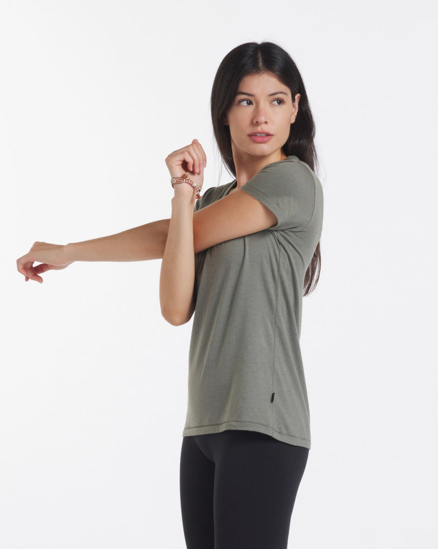 Woman stretching wearing V-Neck looking into distance