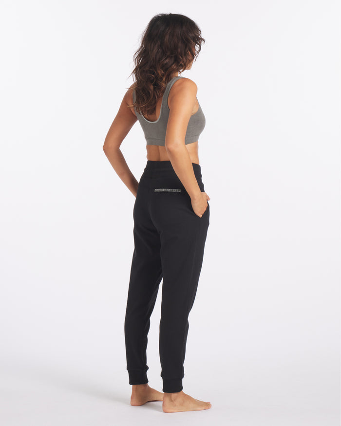 Backside of Model in Sustainable Black Jogger Lounge Pants for Women – PAKA Apparel