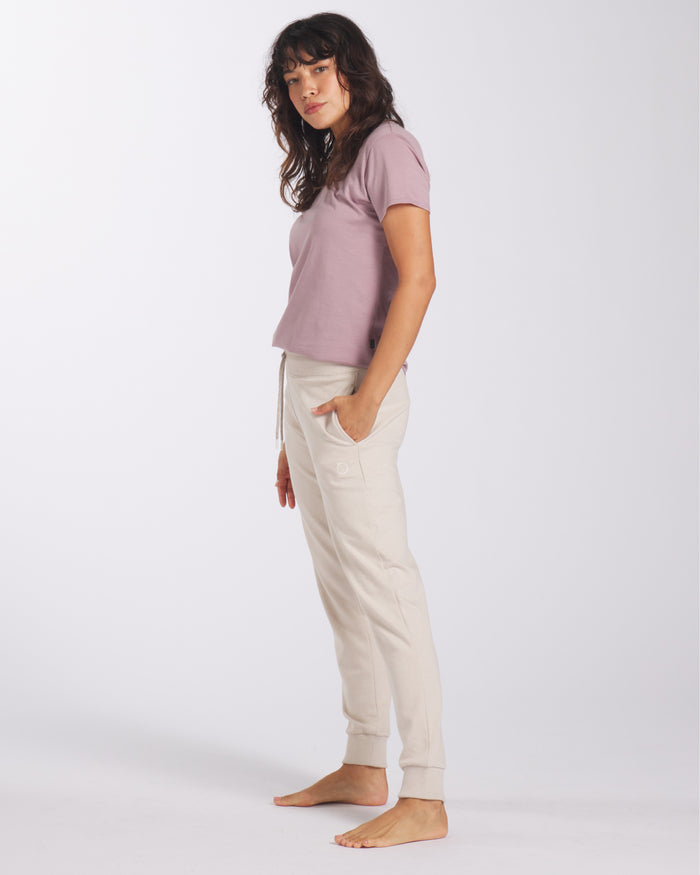 Model Standing Sideways in Women’s Sustainable Jogger Pants in Ivory / Off White – PAKA Apparel