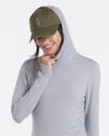 Woman Smiling in Cap with Hood Up on Supernova / Grey “Sol” Sun Protection Hoodie for Hiking and Outdoors – PAKA Apparel