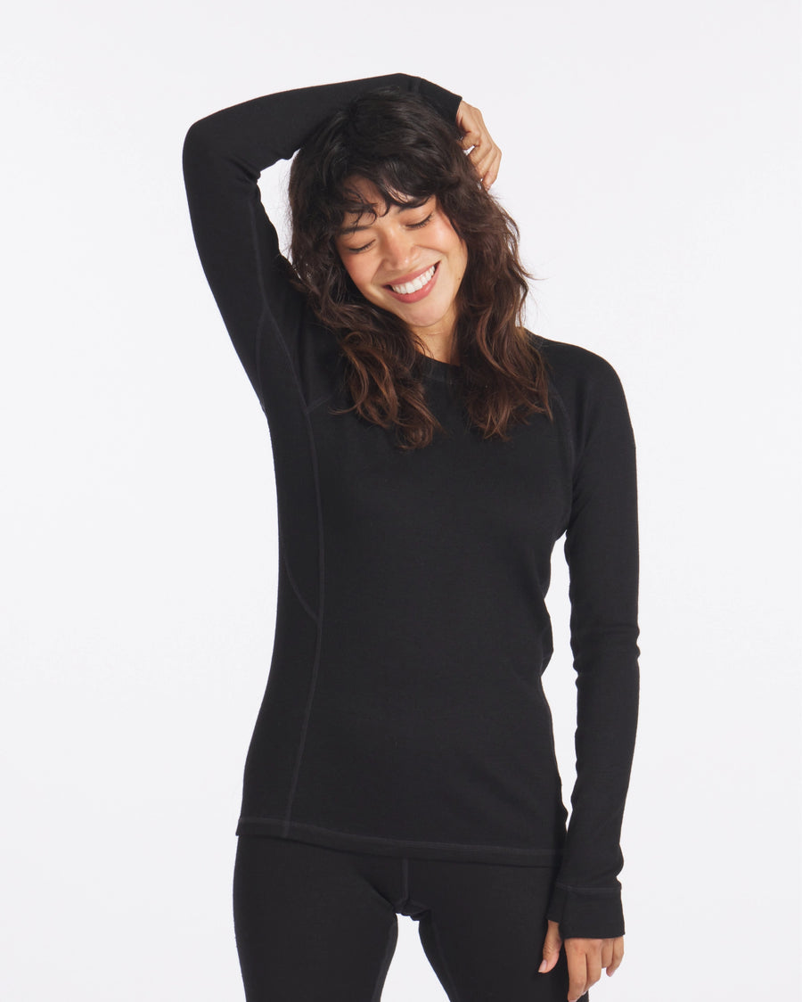 Woman Smiling with Arm Over Head in Black Alpaca Wool Thermal Baselayer Shirt for Winter – PAKA Apparel