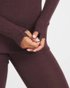 Close-Up of Woman's Hands Together Through Thumbholes of Uva / Dark Purple Alpaca Wool Thermal Long Underwear Top – PAKA Apparel