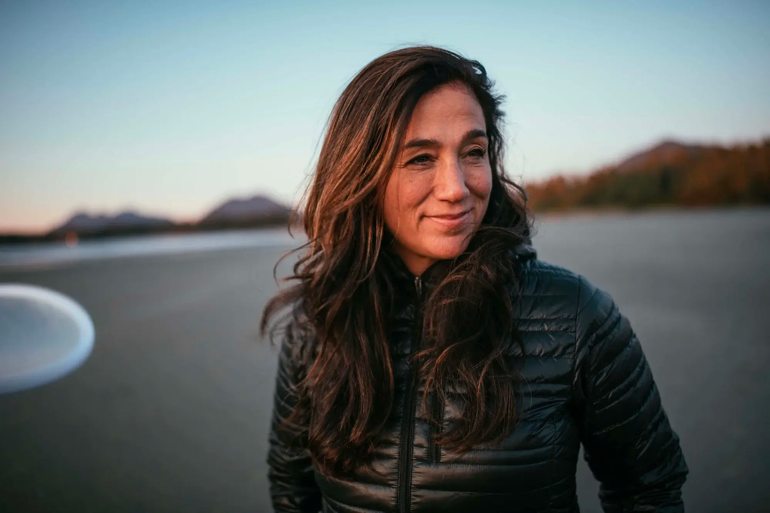 PAKA Ambassador Cristina Mittermeier, Founder of SeaLegacy, in Puffy Jacket with Hills in Background