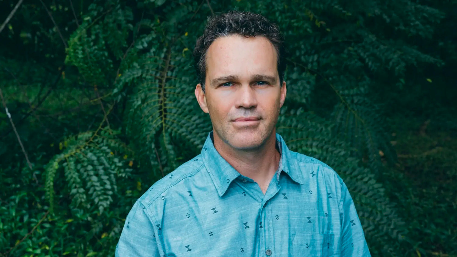 PAKA Ambassador Dr. Zach Bush in Front of Green Plants