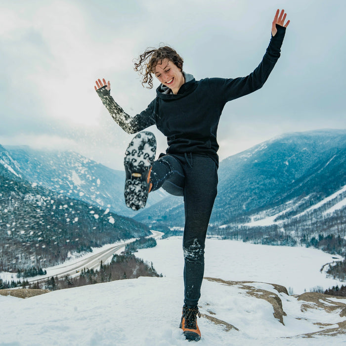 Woman playing in the snow wearing alpaca hoodie 