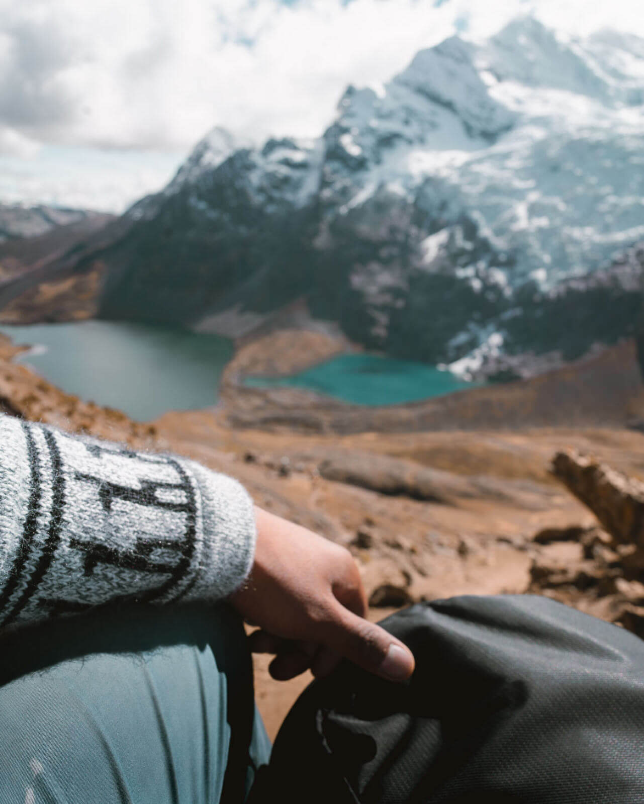 Person Wearing The Costa Alpaca Sweater in Peru Overlooking Lakes at Base of a Mountain - PAKA Apparel