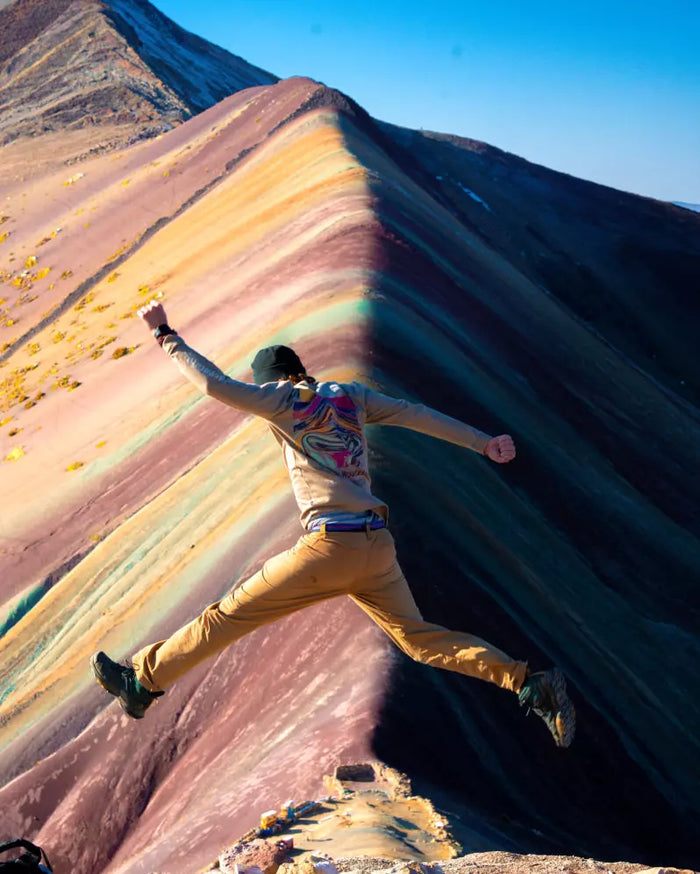 Long sleeve tan rainbow mountain on male model at rainbow mountain