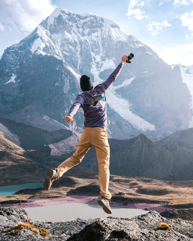 Male Photographer Leaping in Purple Ausangate Graphic Alpaca Long Sleeve Shirt at Base of Ausangate Mountain – PAKA Apparel