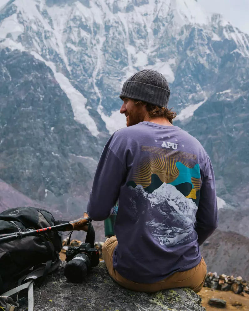 Long sleeve purple Ausangate tee on male model at base of Ausangate 