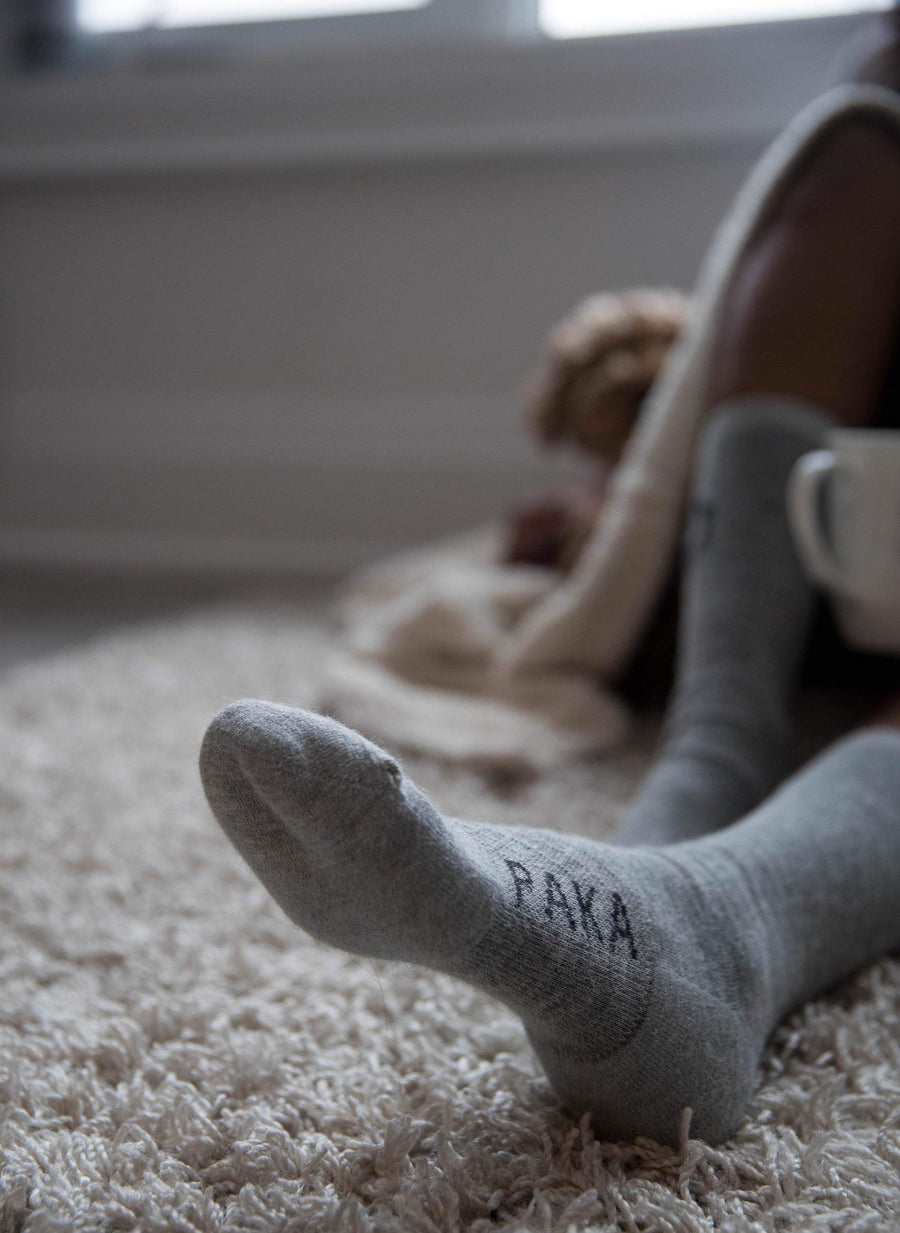 Alpaca socks on rug on woman model