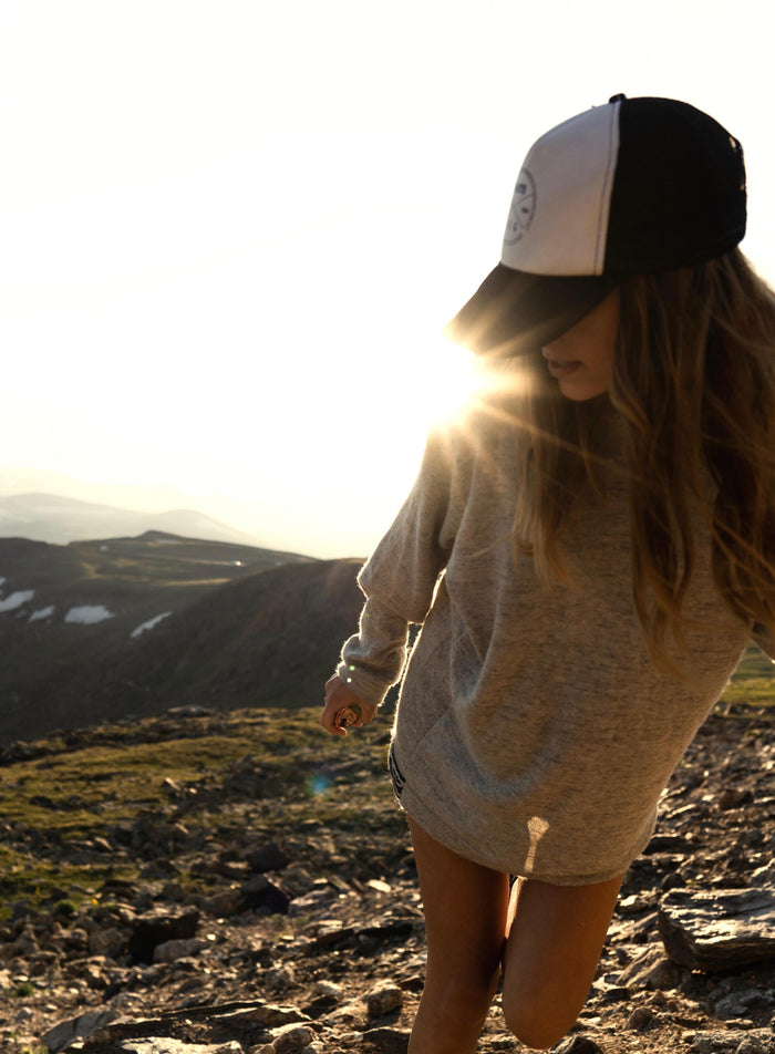 Woman wearing Paka Hoodie during sunset in mountains