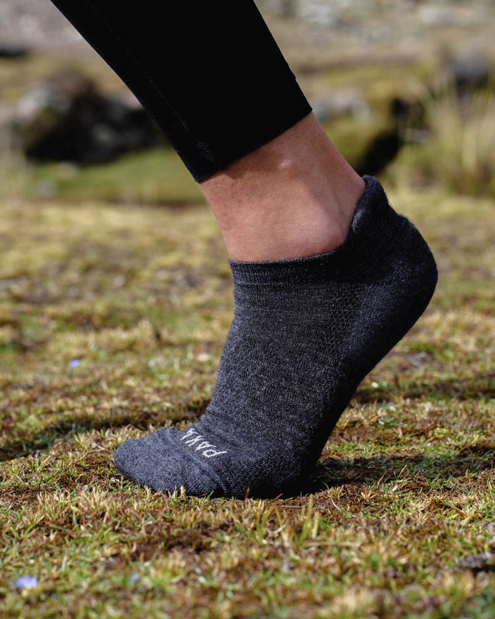 Foot Arched on Grass Wearing Dark Grey Alpaca Wool Ankle Sock from Peru – PAKA Apparel