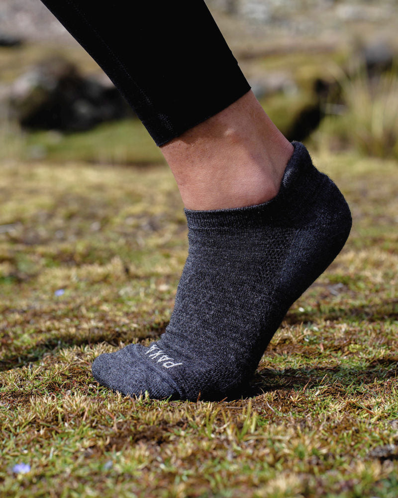 Foot Arched on Grass Wearing Dark Grey Alpaca Wool Ankle Sock from Peru – PAKA Apparel