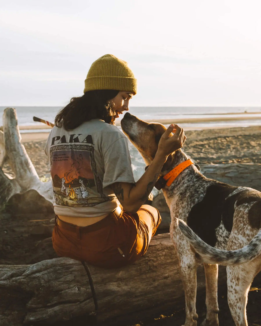 Woman Model wearing Paka t-shirt with puppy around campfire