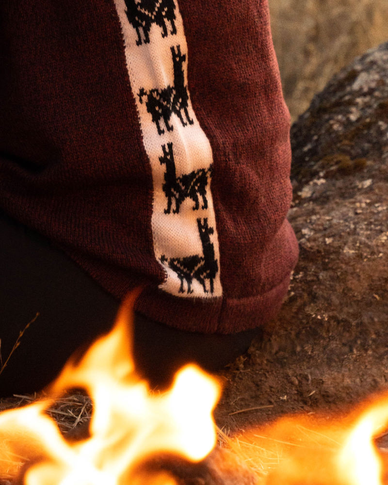 Close Up of Inca Alpaca Side Panel Design in Front of Fire on The Cusco Burgundy / Dark Red Alpaca Wool Sweater from Peru – PAKA Apparel