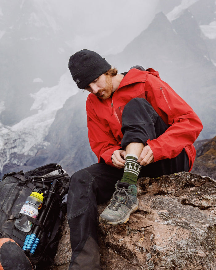 Male Hiker in Snowy Mountains Pulling Up Costa Andean Moss / Dark Green Alpaca Wool Thermal Sock for Colder Weather – PAKA Apparel