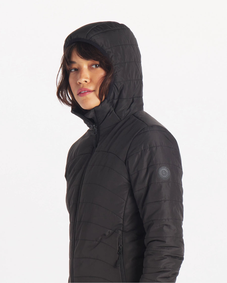 Female Model with Hood Up in Apu Matte Black Women’s Midweight Puffer Jacket with Natural Fiber PAKAFILL® Alpaca Insulation – PAKA Apparel