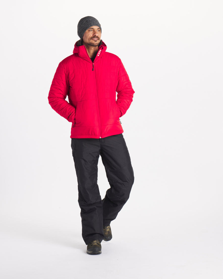 Model in Ski / Snow Pants Wearing Apu Oxblood / Red Men’s Water Resistant Midweight Puffer Jacket with PAKAFILL® Natural Insulation – PAKA Apparel